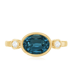 Oval London Blue Topaz Bezel Set Engagement Ring with Diamond
