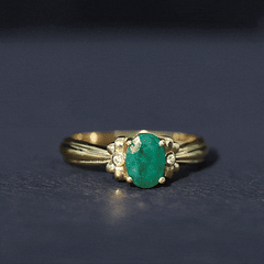 Oval Cut Emerald Solitaire Engagement Ring with Bow Design