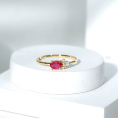 East West Style 0.6 Carat Oval Ruby Promise Ring with Diamond Trio