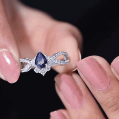 Pear Cut Blue Sapphire and Diamond Crossover Engagement Ring