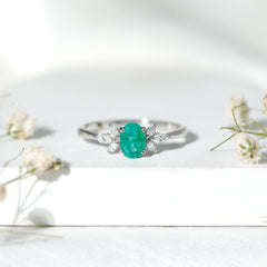 Oval Shaped Emerald Engagement Ring with Marquise Diamond Trio