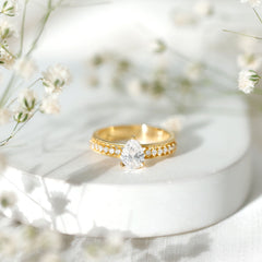 Pear Shaped Moissanite Solitaire Engagement Ring with Beaded Design